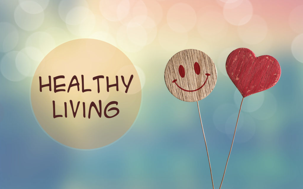 A bubble with the words Healthy Living next to a smiley face and heart balloons against a whimsical background